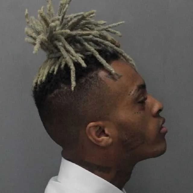XXXTentacion XXXTentacion - A side view mugshot of Jahseh Onfroy, better known as rapper XXXTentacion, after being arrested for seven felony charges related to his 2016 domestic violence case, includi
