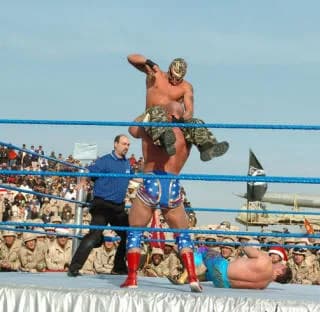Eddie Guerrero - WWE wrestlers Rey Mysterio (Oscar Gutierrez), Kurt Angle and Eddie Guerrero perform for troops in Iraq.