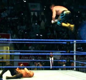 Eddie Guerrero - Eddie Guerrero gives a Frog Splash during his tag team match with Rey Mysterio against the Basham Brothers during a WWE house show held in Kitchener, Ontario, Canada on January 15, 20