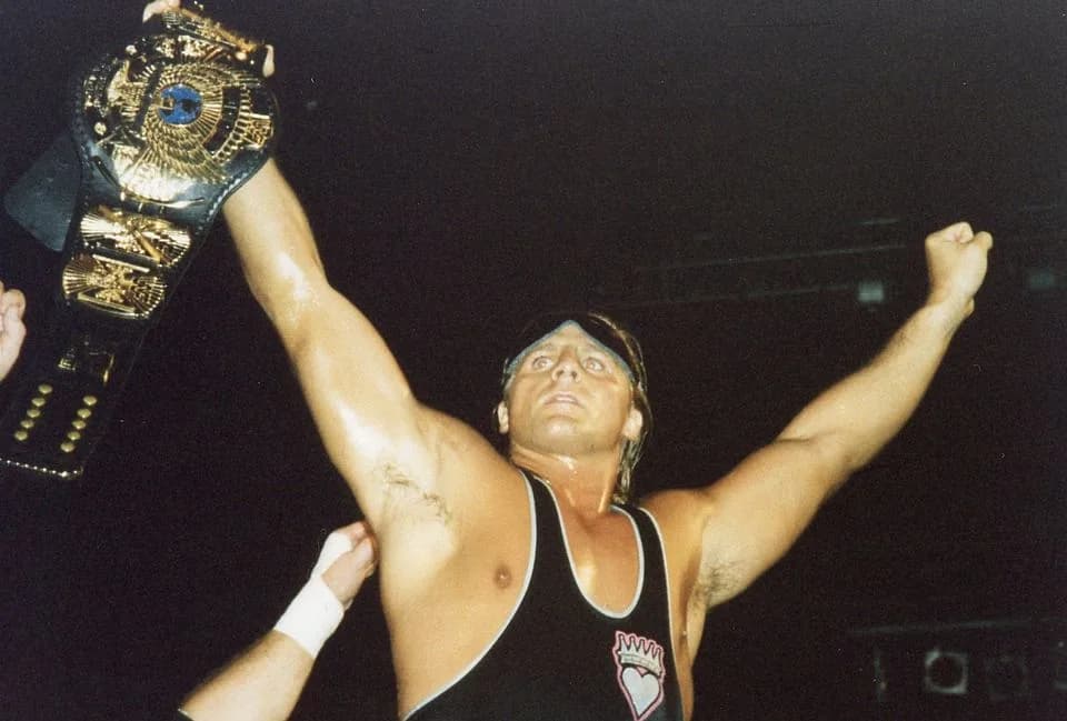 Owen Hart - Professional wrestler Owen Hart with the WWF Championship, the only major championship in the WWF that he didn't win.