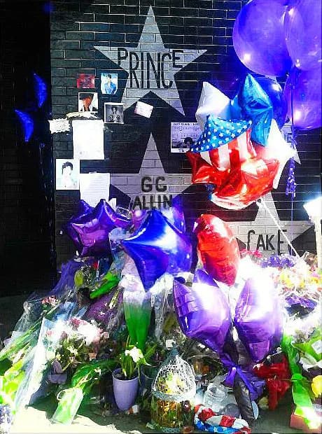 Prince - Grieving fans left various items including CD's, purple balloons, cards, love letters, and a tiny stuffed purple monkey-friend beneath the beloved artist's star painted on the front of the hi