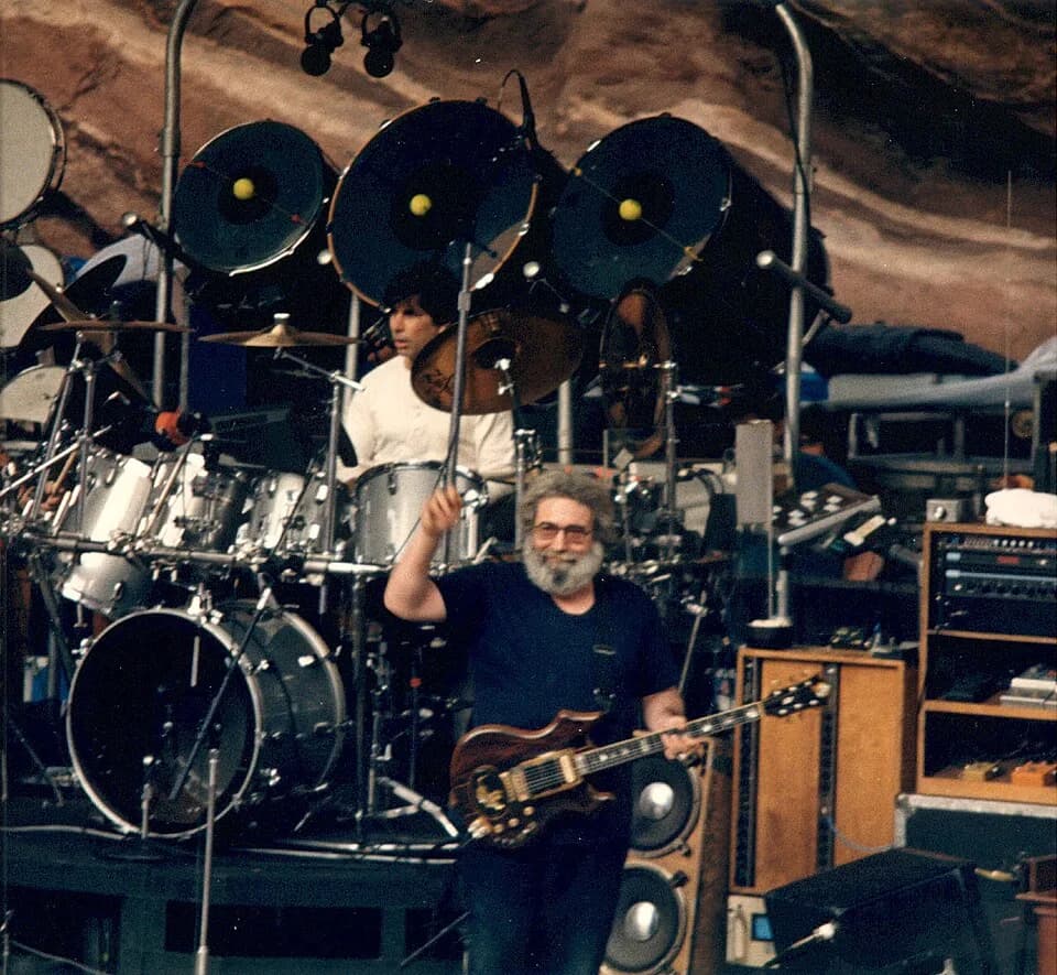Jerry Garcia - Jerry Garcia(playing 'Tiger' (front) and Mickey Hart (playing drums) of the Grateful Dead at Red Rocks Amphitheatre in [[:en:Morrison, 
Colorado|Morrison, Colorado]]. Image from a deadh