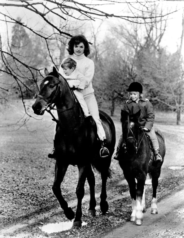 John F. Kennedy Jr. - First Lady Jacqueline Kennedy and her children John F. Kennedy Jr. and Caroline Kennedy riding.