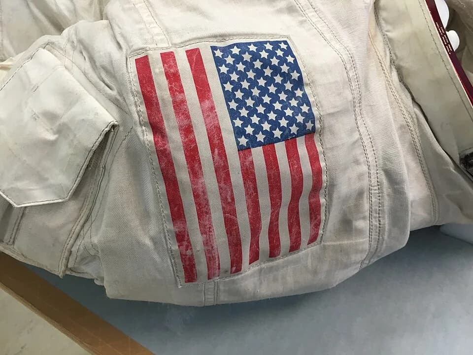 Neil Armstrong - A photo of the United States flag patch located on the left shoulder of Neil Armstrong's Apollo 11 spacesuit at the Smithsonian's Udvar-Hazy Center.