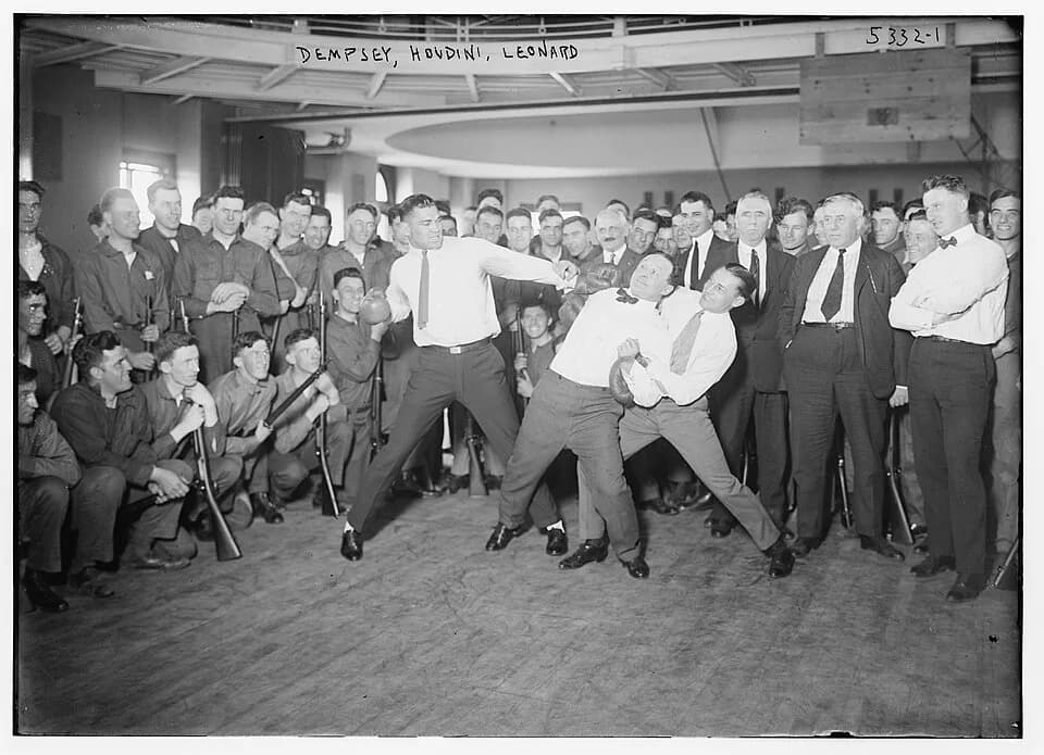 Harry Houdini - "Dempsey, Houdini, Leonard (boxing)". 1 negative : glass ; 5 x 7 in. or smaller. Jack Dempsey (l), Harry Houdini (center), and Benny Leonard (r) spar at a publicity event.