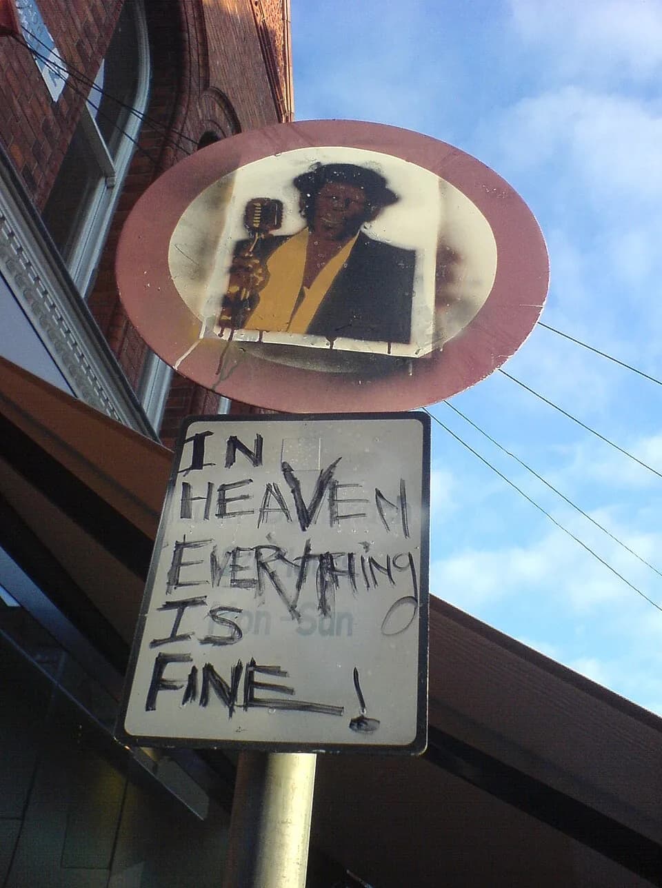 James Brown - A sign with a picture of James Brown and graffiti.