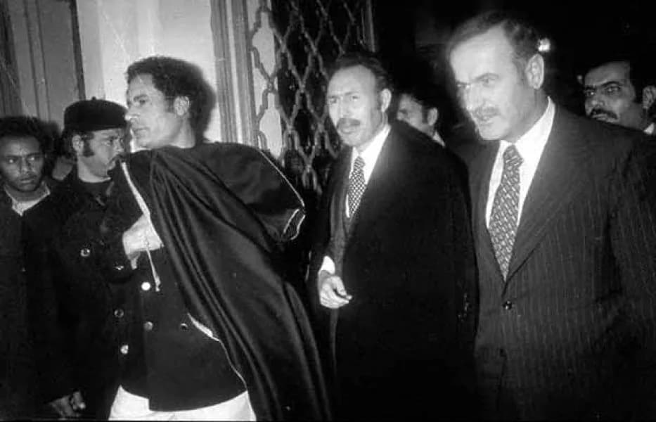 Hawwari Bumadian - Syria's President Hafez al-Assad attending the Steadfastness and Confrontation Summit in Libya in December 1977 / From left to right: Libyan leader Muammar al-Gaddafi, Algerian Pres