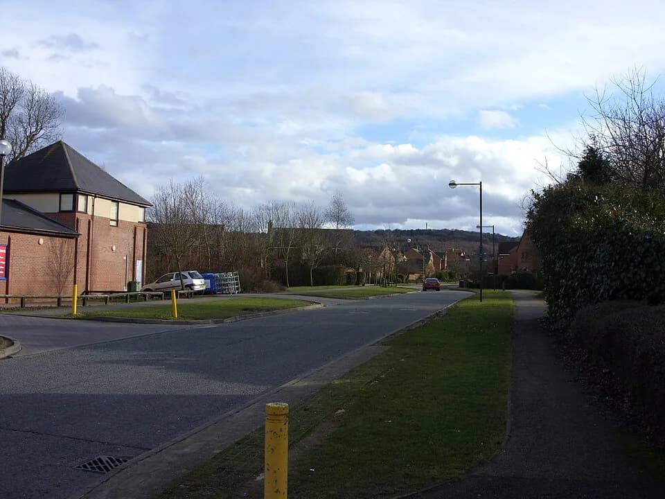 Gustav Holst - Holst Crescent, Old Farm Park One end of the Crescent which lies closest to the small retail zone and adjoins Britten Grove. The storage unit to the shop can be seen on the left of the 
