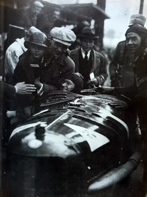 Alberto Ascari - Entry #1 at Monza for the Italian GP at Monza on 19 October 1924 was an Alfa Romeo P2 driven by WINNER Antonio Ascari, sitting in the car. His son Alberto Ascari (born 1918) wears a h