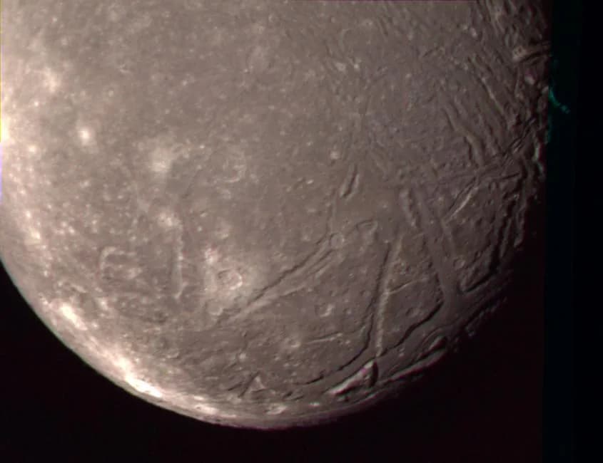 William Lassell - The complex terrain of Ariel is viewed in this image, the best Voyager 2 color picture of the Uranian moon. The individual photos used to construct this composite were taken Jan. 24,