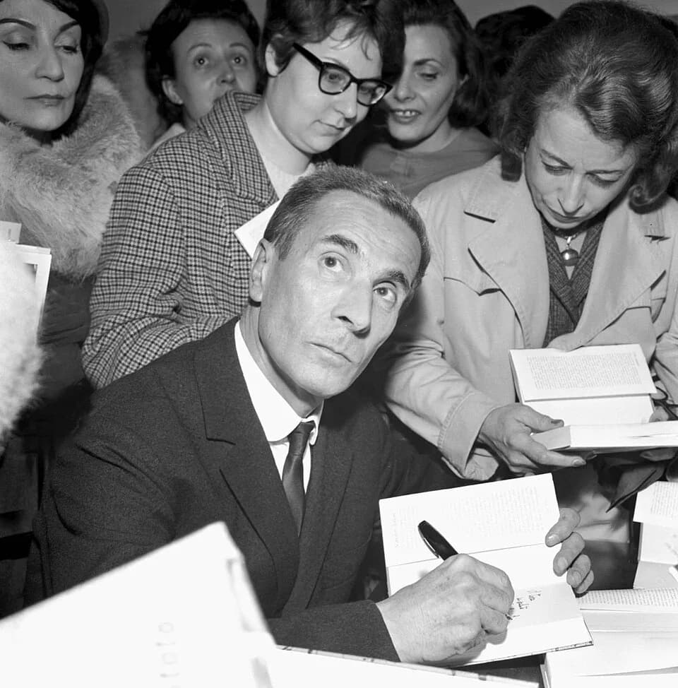 Dino Buzzati - Photograph of the Italian writer Dino Buzzati signing his books in a Milan bookstore.
