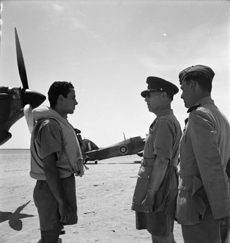 George II of Greece - Royal Air Force Operations in the Middle East and North Africa, 1939-1943.
King George II of Greece talks to a pilot standing in front of his Hawker Hurricane Mark I, during his 