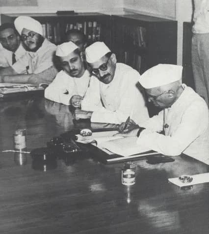 Gulzarilal Nanda - Jawaharlal Nehru signing the report of the Planning Commission on the First Five Year Plan, New Delhi, 7 July 1951. Also seen, from left:- K.N. Raj, Tarlok Singh, R.K. Patil and G.L