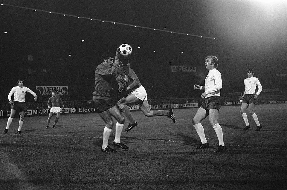 Bobby Moore - Peter Bonetti saves a football with opponents and teammates look on in a football match aganist the Netherlands on 5 November 1969