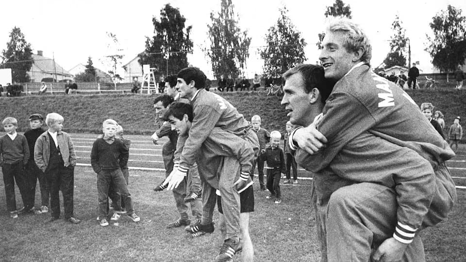 Denis Law - Photograph of some ManU players during their visit in Hämeenlinna, Finland. In front Pat Crerand carrying Denis Law; middle George Best carrying Tony Dunne; back Noel Cantwell carrying Pat