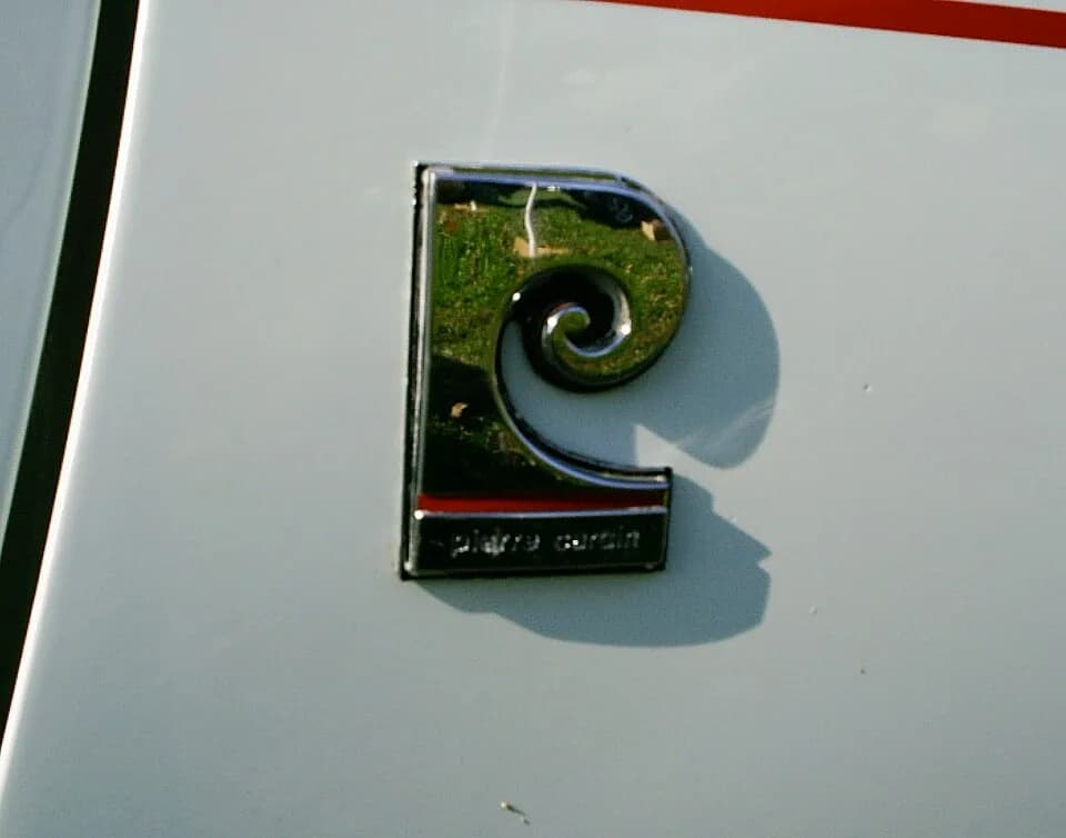 Pierre Cardin - The Pierre Cardin emblem on the front fender of Javelins with the optional designer interior that was available in American Motors Corporation (AMC) Javelin SST "pony car" during the 1