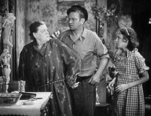 Marie Dressler - Frame from the public domain trailer for MGM's film Min and Bill (1930) showing Marie Dressler, Wallace Beery and Dorothy Jordan