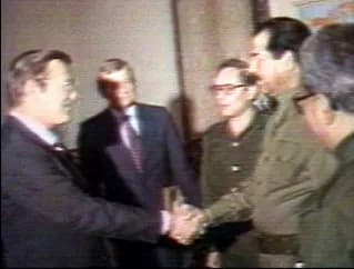 Tariq Aziz - Original caption:"Shaking Hands: Iraqi President Saddam Hussein greets Donald Rumsfeld, then special envoy of President Ronald Reagan, in Baghdad on December 20, 1983." As this is a simpl