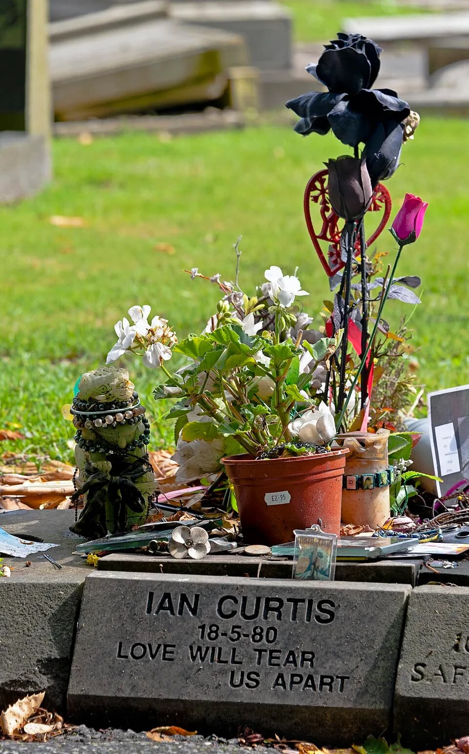 Ian Curtis - Grave of Joy Division lead singer Ian Curtis in Macclesfield Cemetery, with mementoes left by visitors.