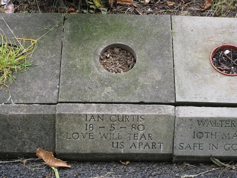 Ian Curtis - View of the grave of Ian Curtis. The curbstone bears the inscription:
Ian Curtis
18 - 5 - 80

Love Will Tear Us Apart