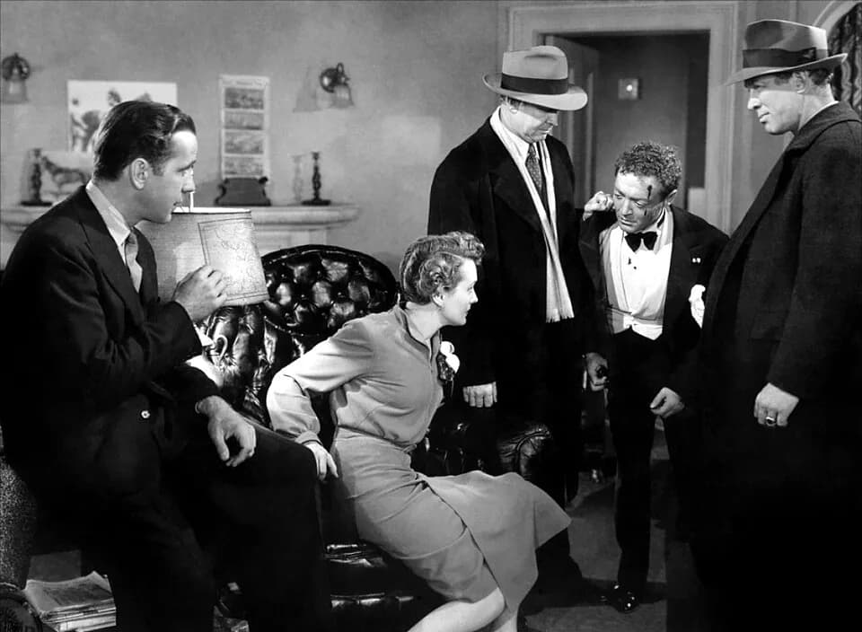 Peter Lorre - Promotional still from the 1941 film The Maltese Falcon, published on page 12 of National Board of Review Magazine. 
L-R: Humphrey Bogart, Mary Astor, Barton MacLane, Peter Lorre, Ward B
