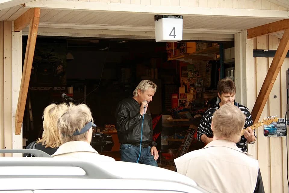Matti Nykänen - Matti Nykänen singing and joking with his guitarist during a performance held at a car repair parts shop in Kirkkonummi, on the 19th of June 2010.