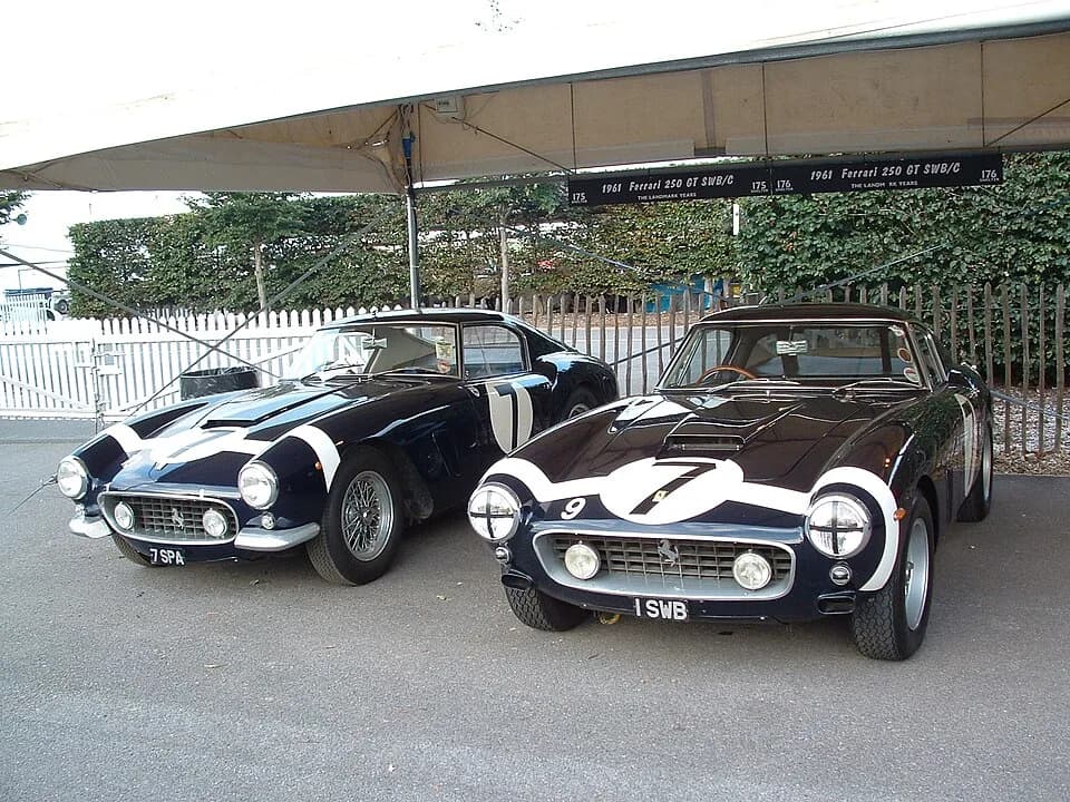 Graham Hill - Two 250GT SWBs at the 2004 Goodwood Revival.  At left is 1960 "7SPA", chassis #2119GT. At right is 1961 "1SWB" chassis #2735GT.[1]