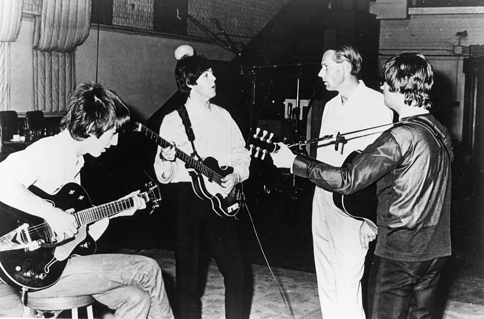 George Martin - Publicity photo of the Beatles with producer George Martin in the studio at Abbey Road. Only John Lennon, George Harrison and Paul McCartney are pictured.