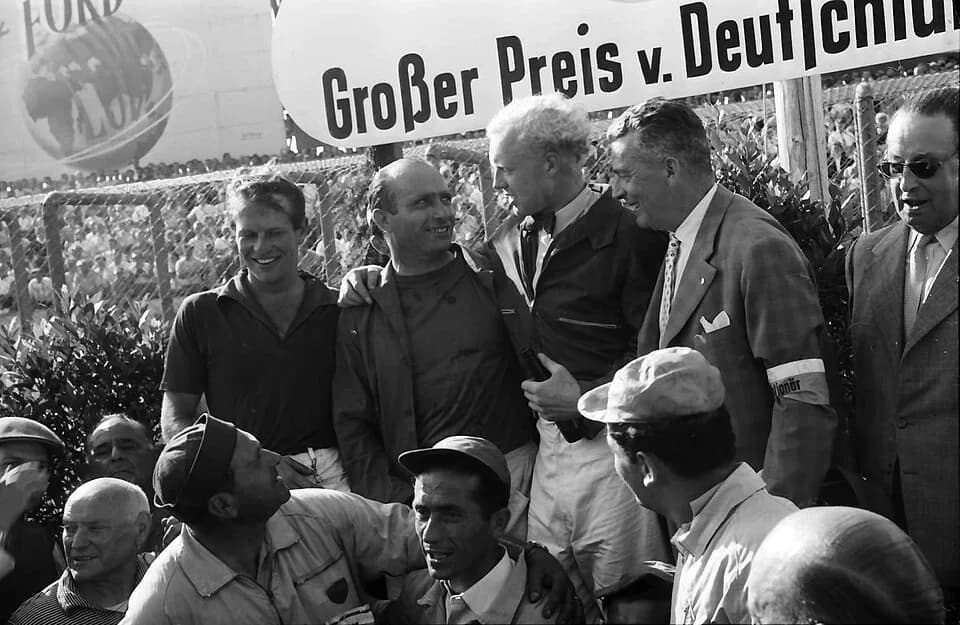 Mike Hawthorn - The top three finishers in the 1957 German Grand Prix on the podium following the race. From the left of the podium group are third-placed Peter Collins (Ferrari), race winner Juan Man