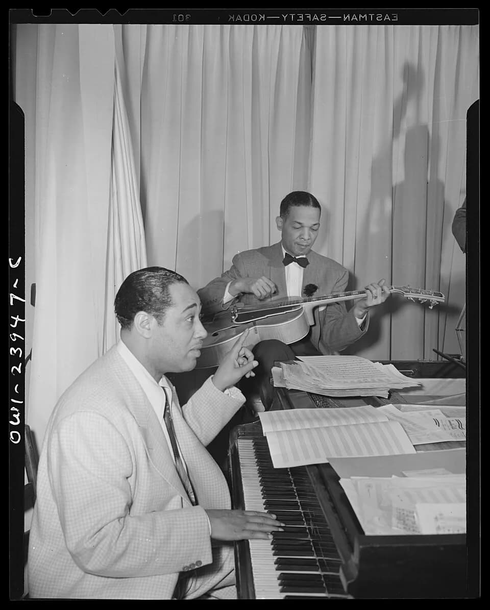 Duke Ellington - Duke Ellington directing his band from the piano at the Hurricane cabaret