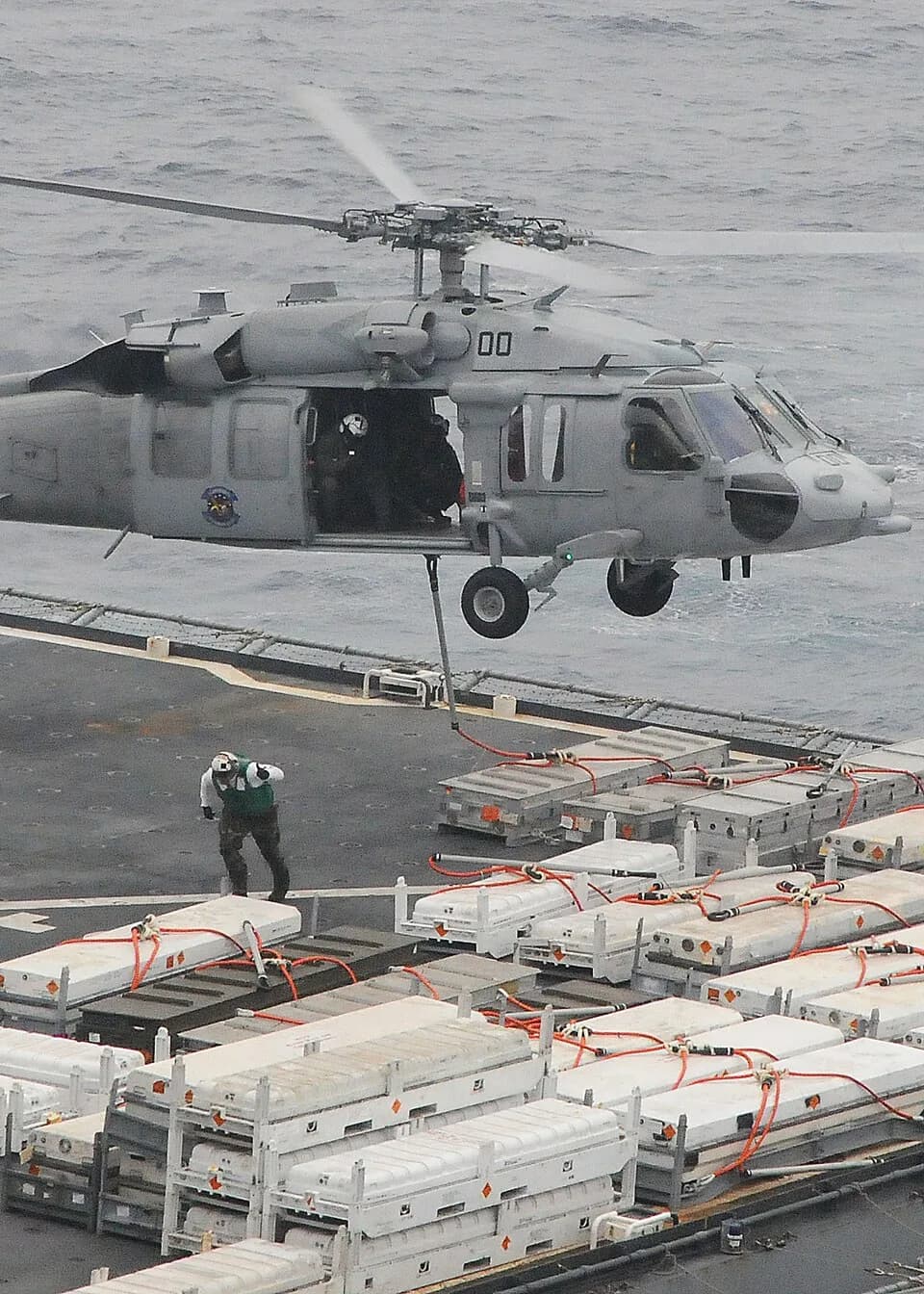 Alan Shepard - PACIFIC OCEAN  (May 11, 2009) A crew member of the Military Sealift Command dry cargo/ammunition ship USNS Alan Shepard (T-AKE 3) moves clear after slinging a load under an MH-60S Sea H