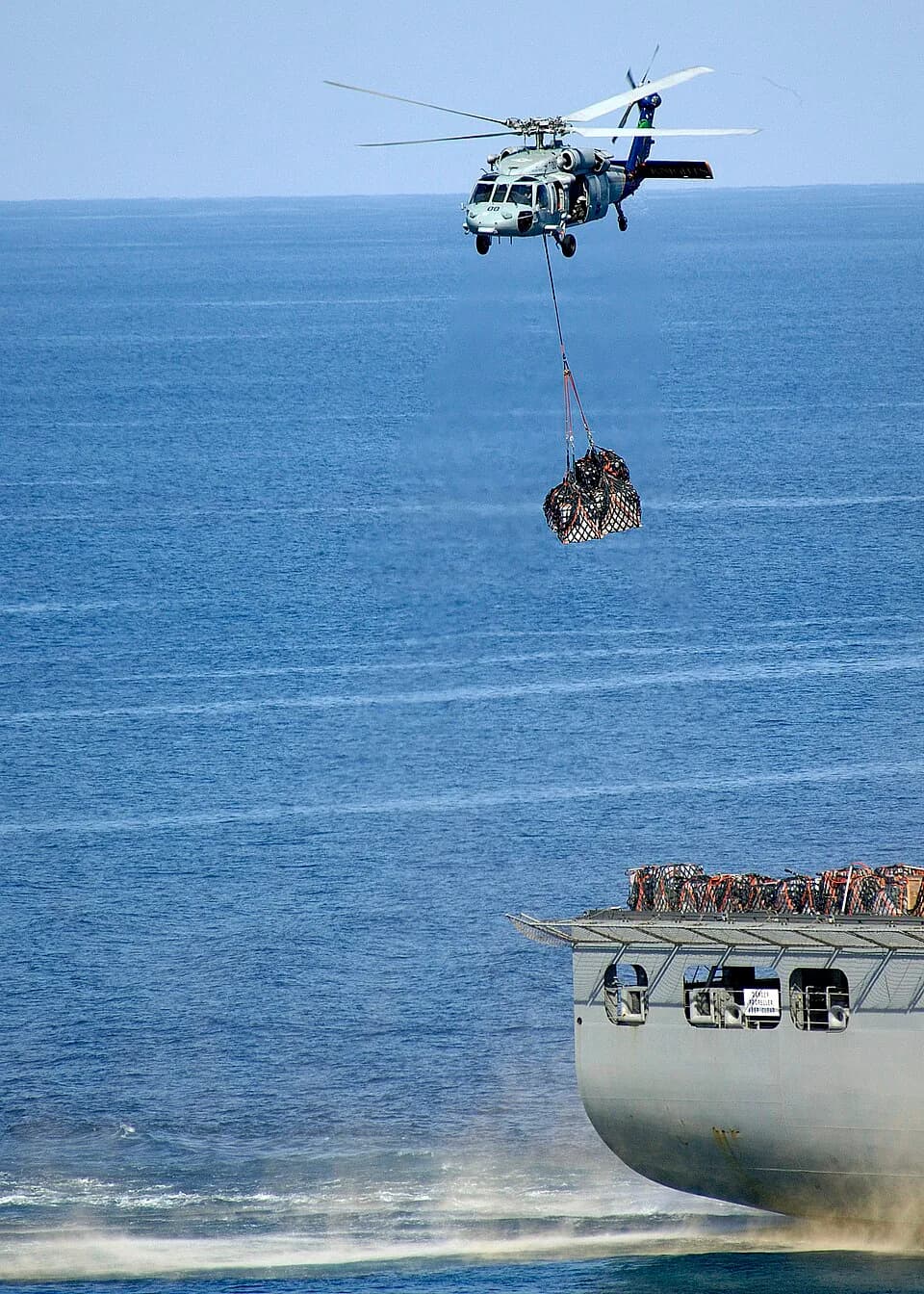 Alan Shepard - PACIFIC OCEAN (July 25, 2009) An MH-60S Sea Hawk helicopter from the Island Knights of Helicopter Combat Squadron (HSC) 25 lifts supplies from the flight deck of the Military Sealift Co