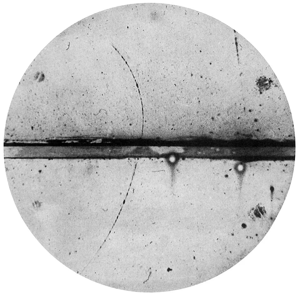 Carl David Anderson - Cloud chamber photograph of the first positron ever observed. The thick horizontal line is a lead plate. The positron entered the cloud chamber in the lower left, was slowed down
