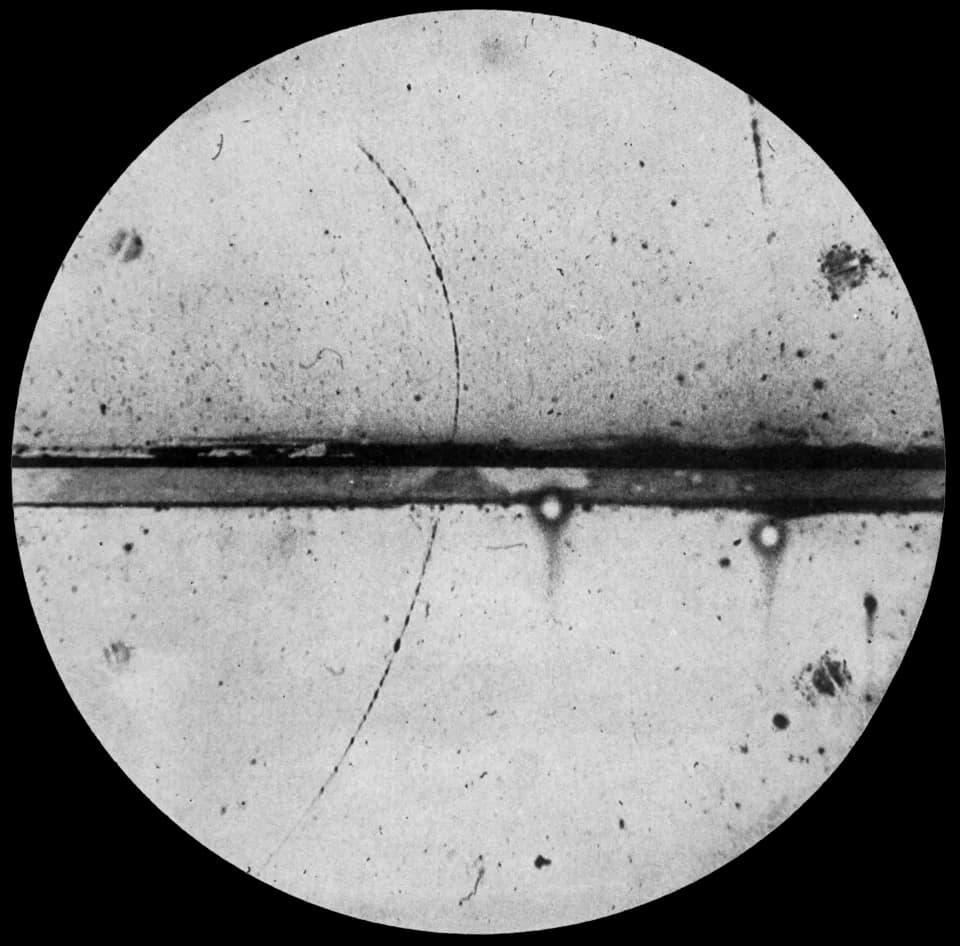Carl David Anderson - Cloud chamber photograph of the first positron ever observed. The thick horizontal line is a lead plate. The positron entered the cloud chamber in the lower left, was slowed down