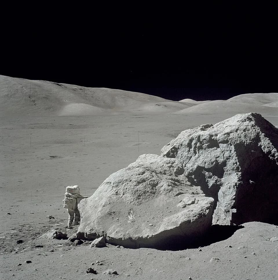 Eugene Cernan - The Apollo 17 Lunar Roving Vehicle (LRV) is photographed near a large lunar boulder, nicknamed "Tracy's Rock", during the third Apollo 17 extravehicular activity (EVA) at the Taurus-Li