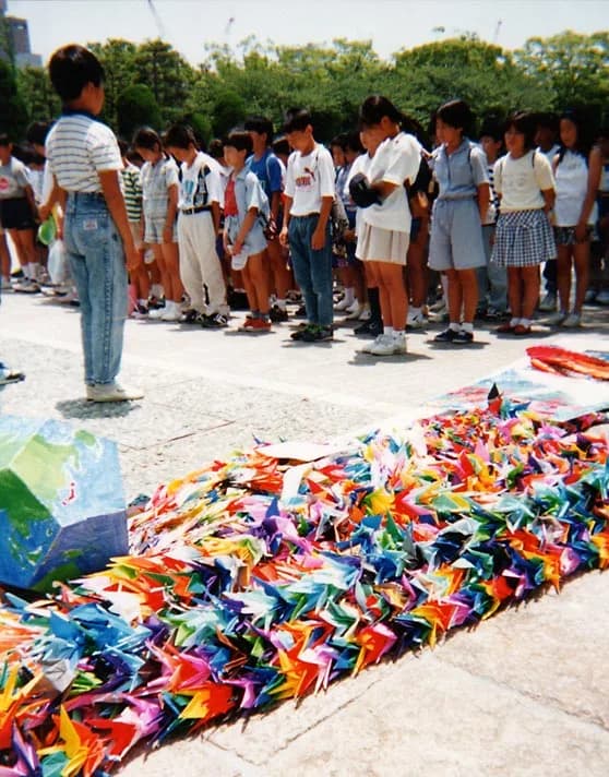 Sadako Sasaki - Senbazuru (千羽鶴) - or 1000 cranes. Japanese school children dedicate a collection of paper origami cranes they are delivering to the memorial for Sadako Sasaki in Hiroshima Peace Park. 