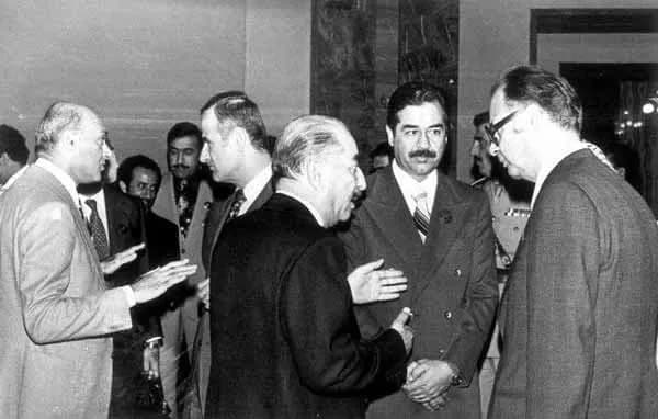 Ahmed Hassan al-Bakr - President Hafez al-Asad of Syria (centre, background) at an Arab Summit in Baghdad in November 1978. Standing near him, having a separate conversation, are Iraqi President Ahmad