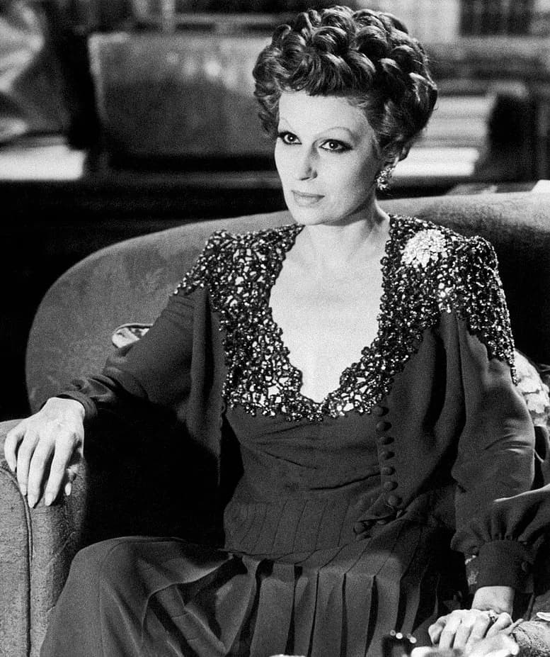 Silvana Mangano - Italian actress Silvana Mangano sitting in an armchair in the film Conversation Piece. Rome, 1974