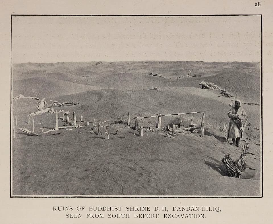 Aurel Stein - Ruins of Buddhist shrine D.II., Dandan-Uiliq, seen from south before excavation.