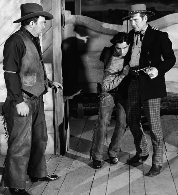 Walter Huston - Left to right: Thomas Mitchell, Jack Buetel, and Walter Huston in The Outlaw (1943) - cropped screenshot