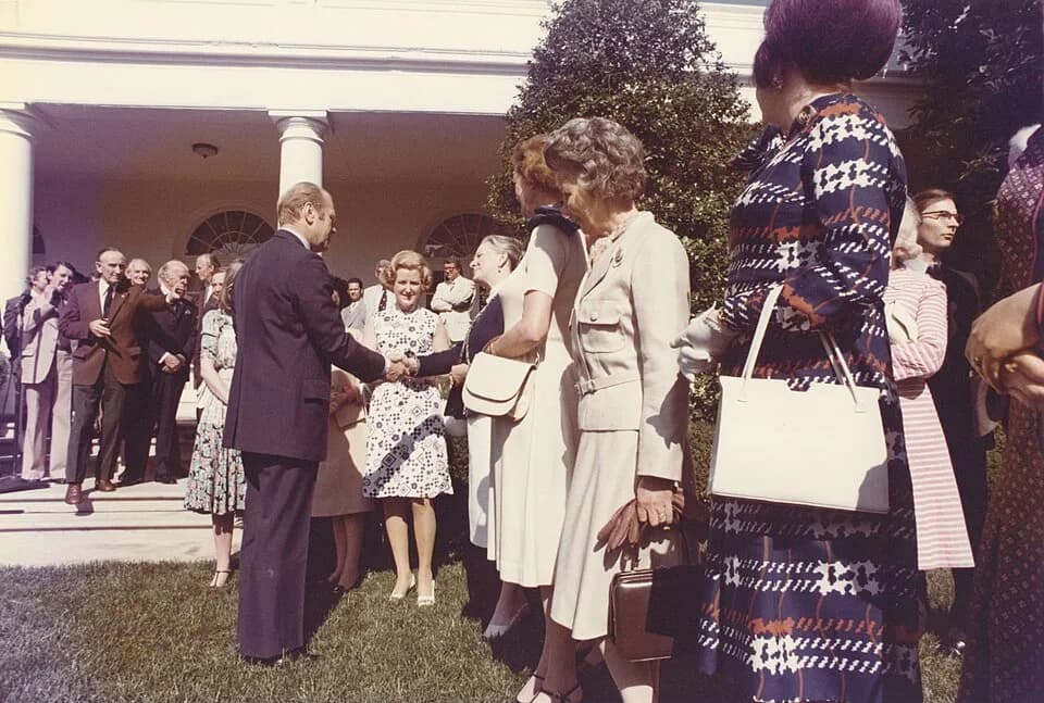 Gerald Ford - Color photograph print of Gerald R. Ford shaking hands with unidentified women during the British Magna Carta Delegation at the White House. June 4, 1976