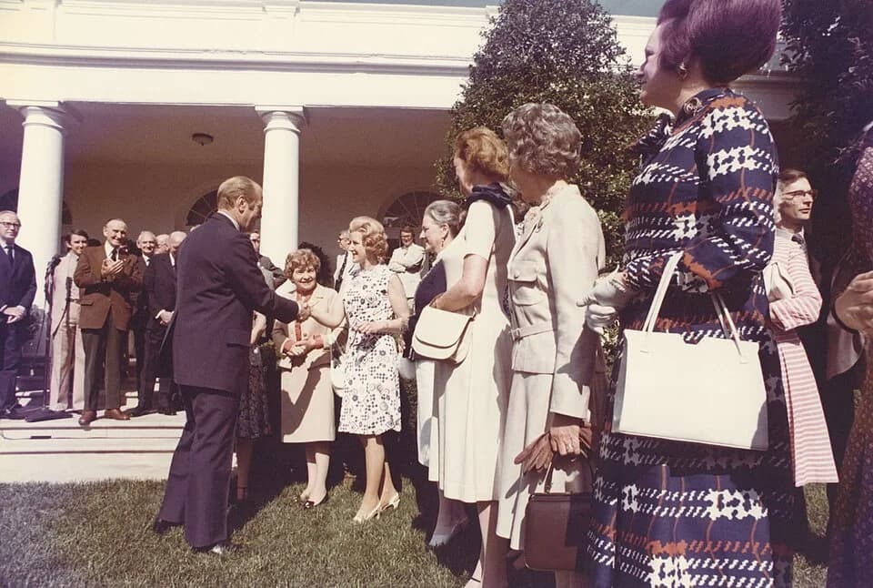Gerald Ford - Color photograph print of Gerald R. Ford shaking hands with unidentified women during the British Magna Carta Delegation at the White House. June 4, 1976