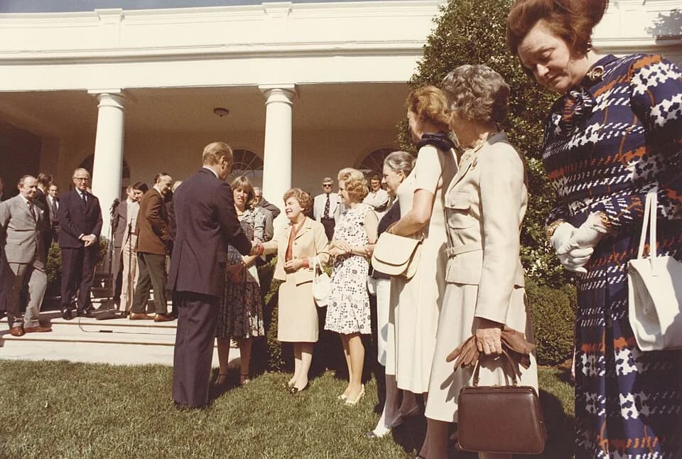 Gerald Ford - Color photograph print of Gerald R. Ford shaking hands with unidentified women during the British Magna Carta Delegation at the White House. June 4, 1976