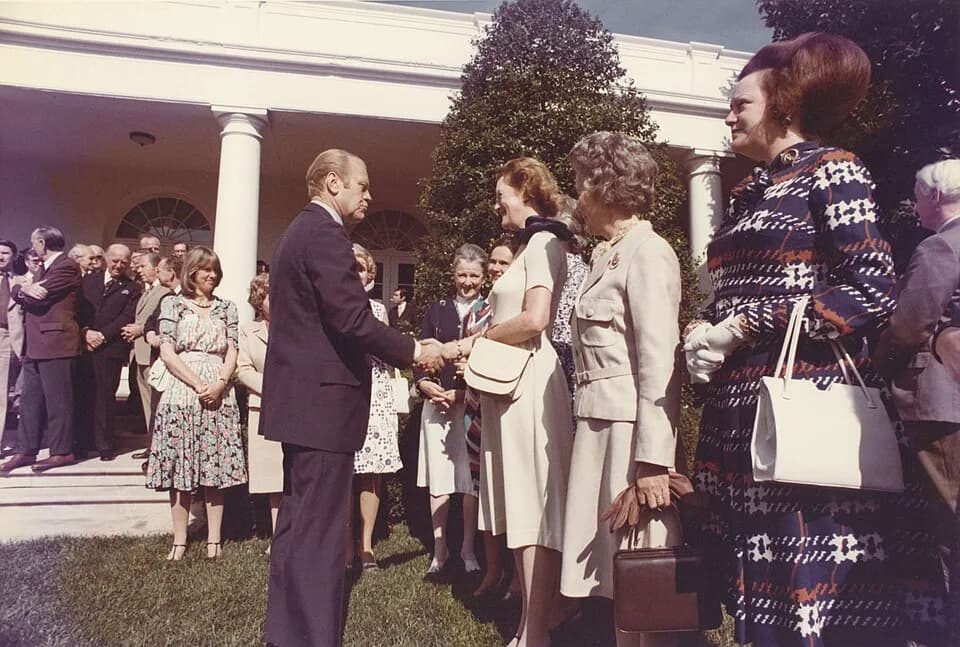 Gerald Ford - Color photograph print of Gerald R. Ford shaking hands with unidentified women during the British Magna Carta Delegation at the White House. June 4, 1976