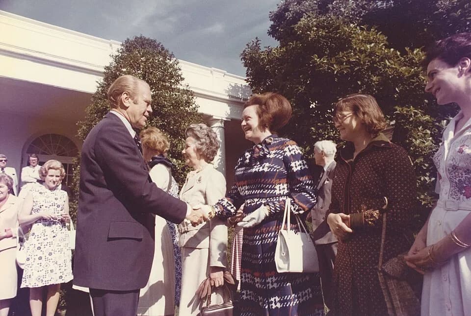 Gerald Ford - Color photograph print of Gerald R. Ford shaking hands with unidentified women during the British Magna Carta Delegation at the White House. June 4, 1976