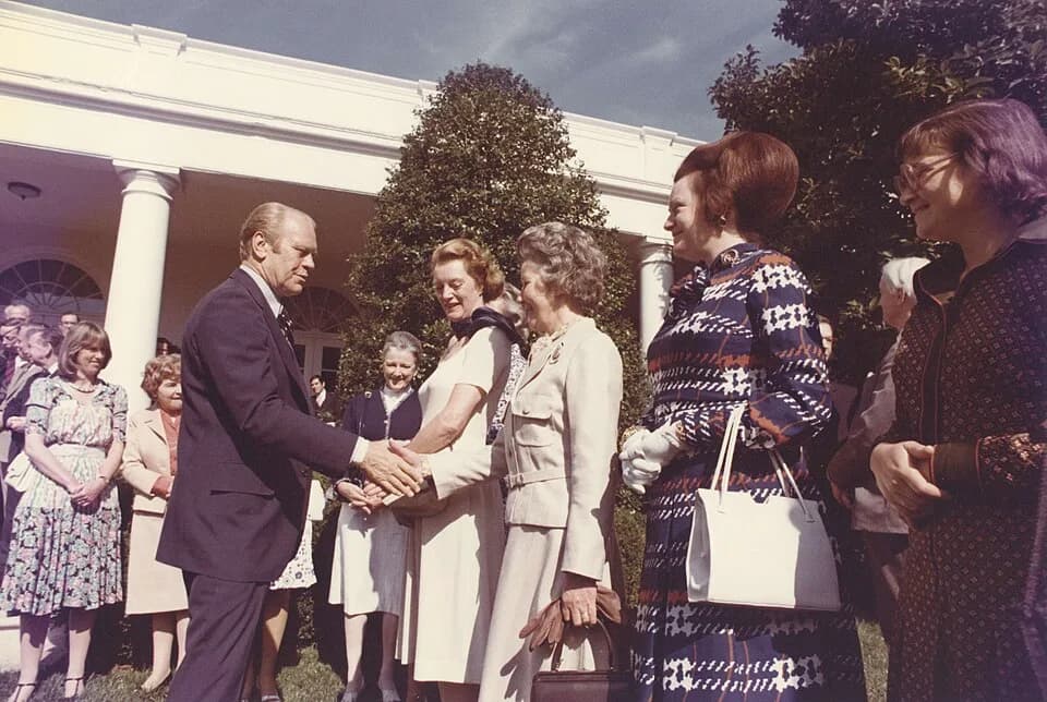Gerald Ford - Color photograph print of Gerald R. Ford shaking hands with unidentified women during the British Magna Carta Delegation at the White House. June 4, 1976