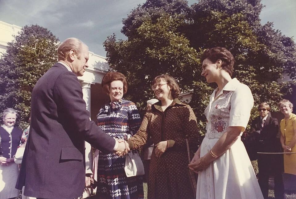 Gerald Ford - Color photograph print of Gerald R. Ford shaking hands with unidentified women during the British Magna Carta Delegation at the White House. June 4, 1976
