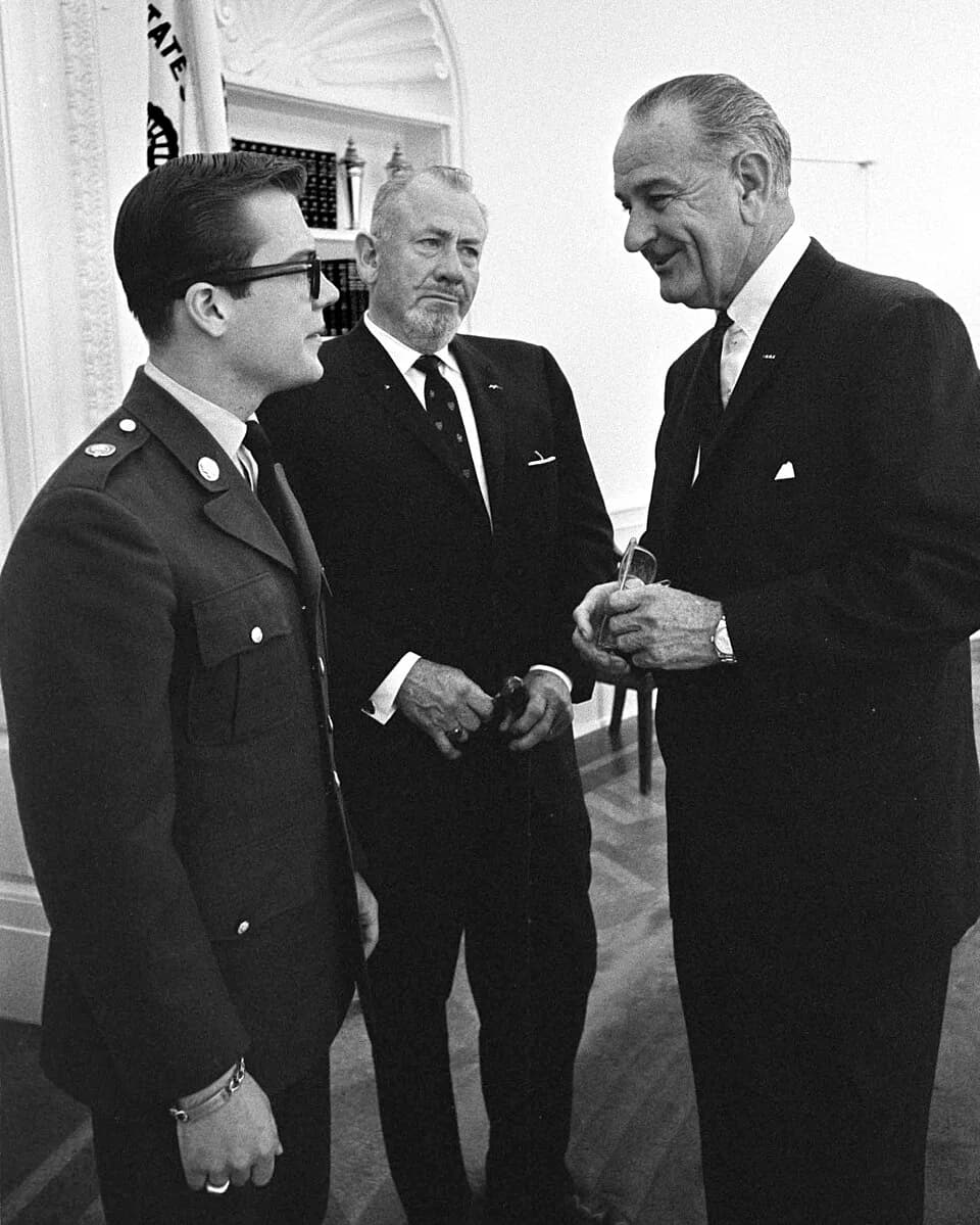 John Steinbeck - John Steinbeck and son John visit LBJ at the oval office in the White House.
To the left is 19 year-old John Steinbeck, IV with his father, John Steinbeck, III. The senior Steinbeck,