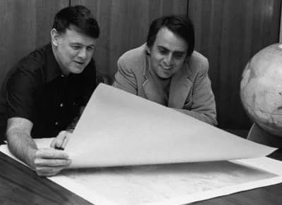 Carl Sagan - Murray and his friend, Carl Sagan, look at a map of Mars. The picture was taken in 1976 in Murray's office while Sagan was living in Pasadena and working on the Viking mission.