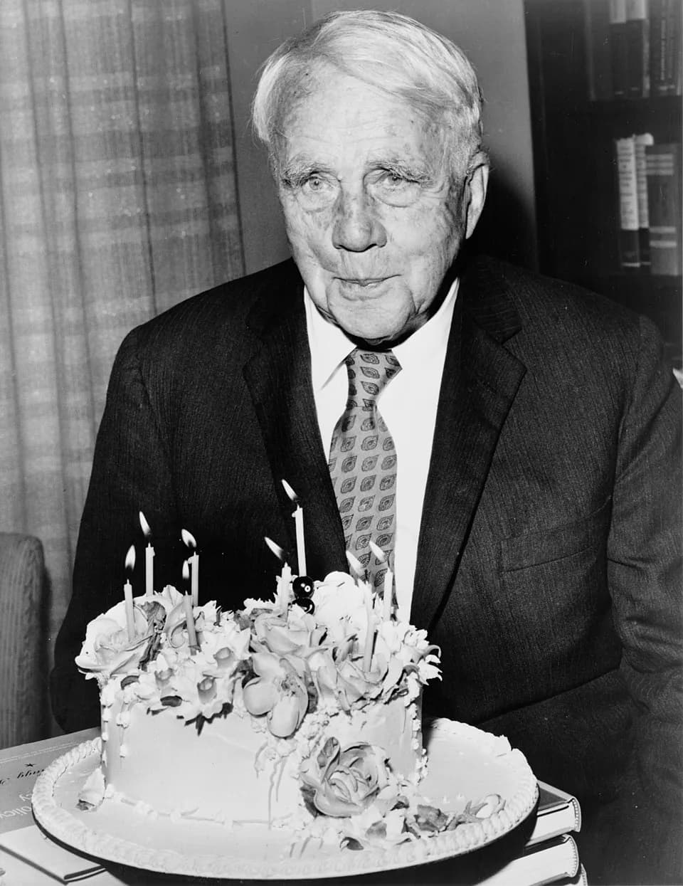 Robert Frost - Robert Frost poses with his birthday cake on his 85th birthday. Waldorf-Astoria hotel in New York City.